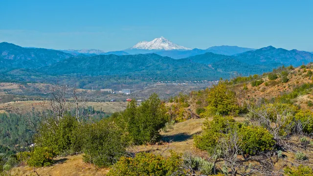 a view of a lush green hillside and a building