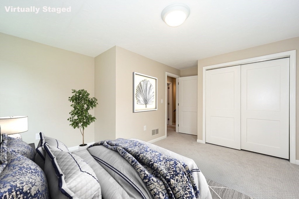 7 - Sherman Terrace, Unit 7 Natick, MA 01760 - Photo 17 of 26 a bedroom with a bed and a potted plant