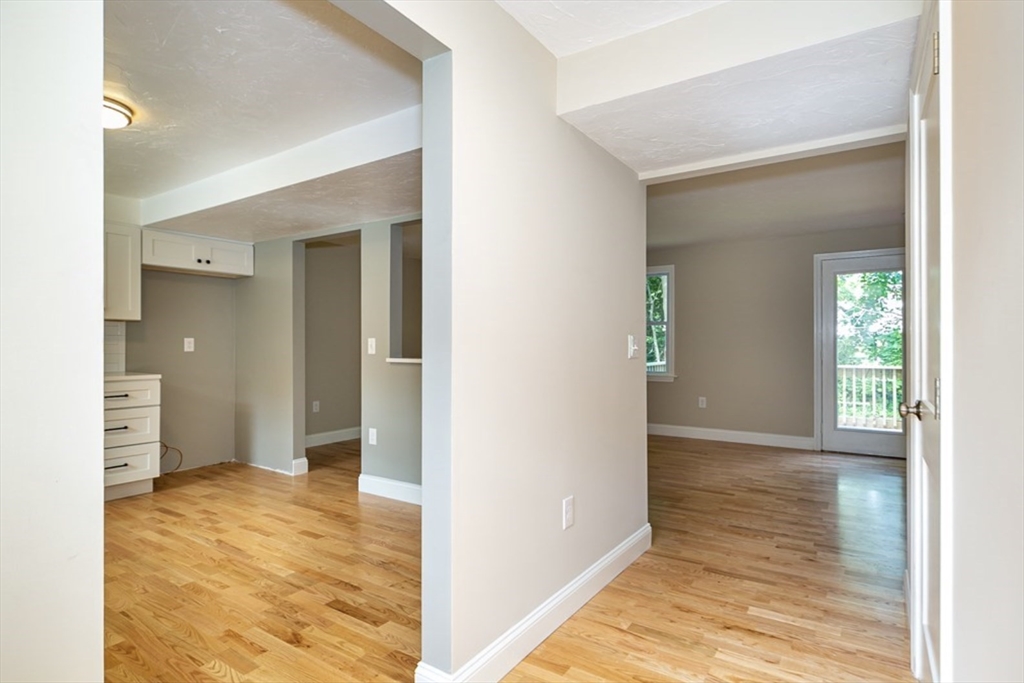 7 - Sherman Terrace, Unit 7 Natick, MA 01760 - Photo 3 of 26 a view of an empty room with kitchen and a window
