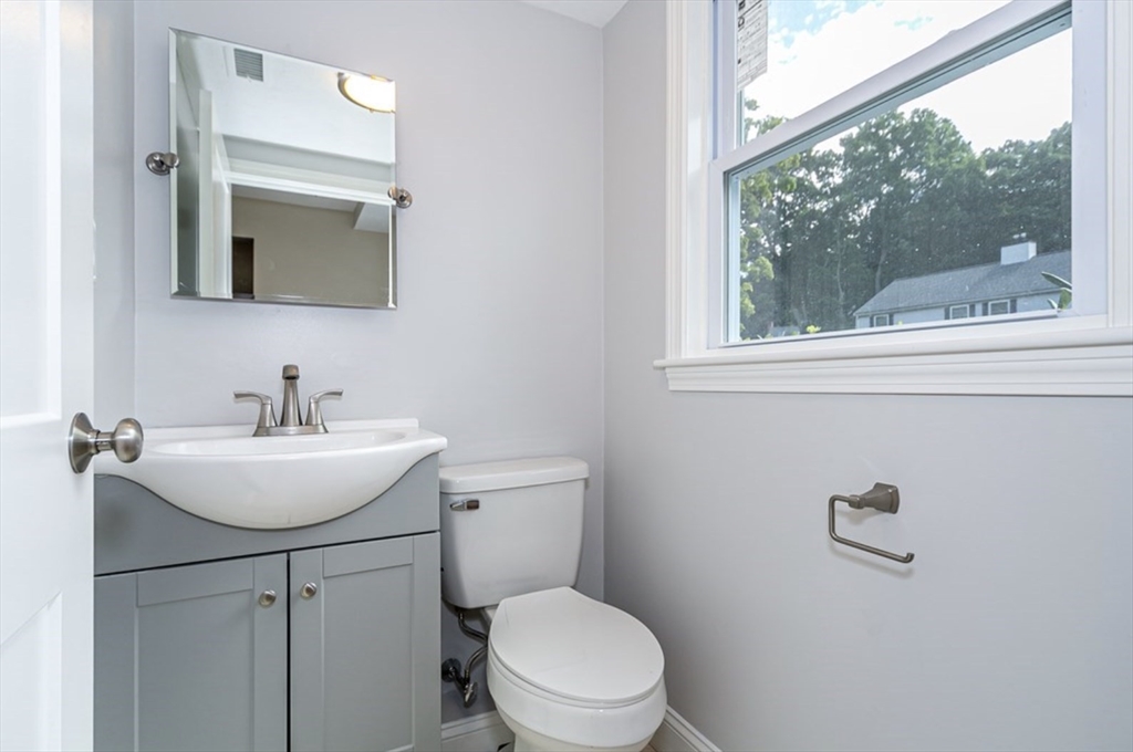 7 - Sherman Terrace, Unit 7 Natick, MA 01760 - Photo 4 of 26 a bathroom with a toilet a sink a mirror and a window