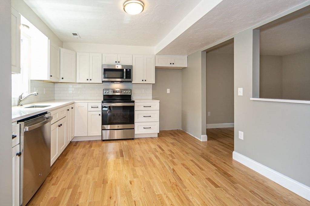 7 - Sherman Terrace, Unit 7 Natick, MA 01760 - Photo 8 of 26 a kitchen with stainless steel appliances a stove top oven and cabinets