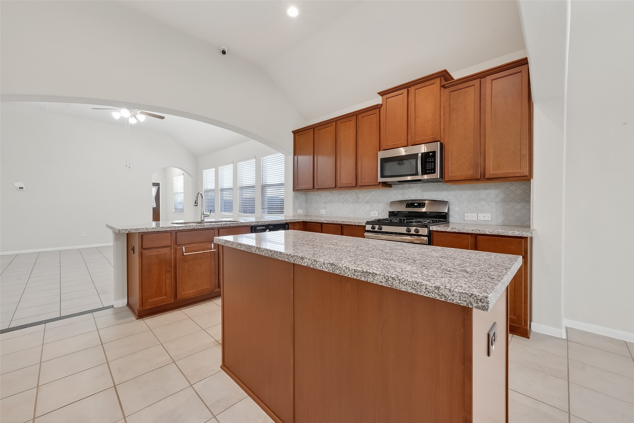 7631 Granite Terrace Lane Houston, TX 77083 - Photo 18 of 46 a kitchen with stainless steel appliances granite countertop a stove a sink and a microwave