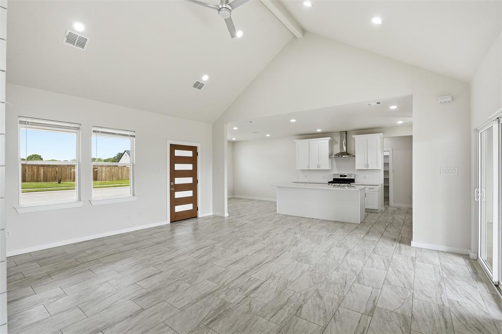 532 Highview Court Godley, TX 76044 - Photo 27 of 39 Open-concept interior featuring light gray wood-finish tile flooring, vaulted ceilings, and recessed lighting