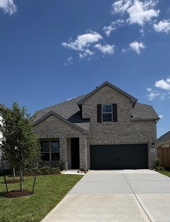 15166 Wild Gully Way Conroe, TX 77302 - Photo 2 of 21 a front view of a house with a yard