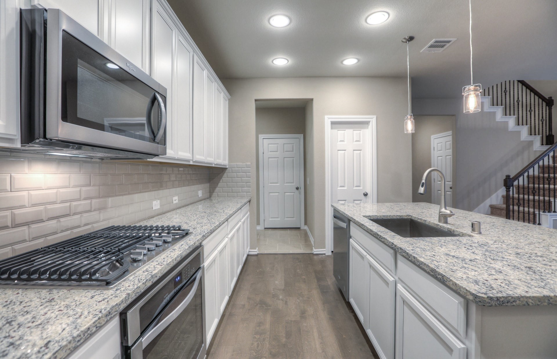 15166 Wild Gully Way Conroe, TX 77302 - Photo 8 of 21 a kitchen with a stove and a sink