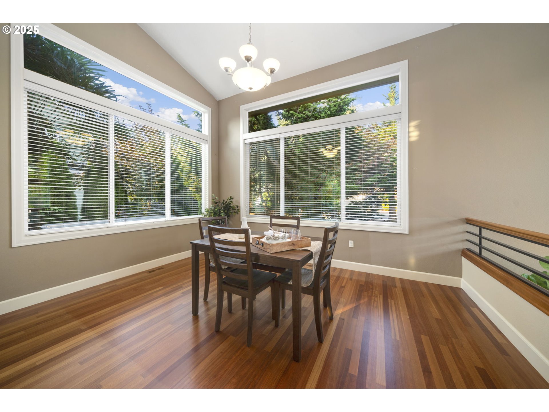 5219 Northwest Fernridge Drive Camas, WA 98607 - Photo 17 of 48 a dining room with wooden floor a chandelier a wooden table and chairs