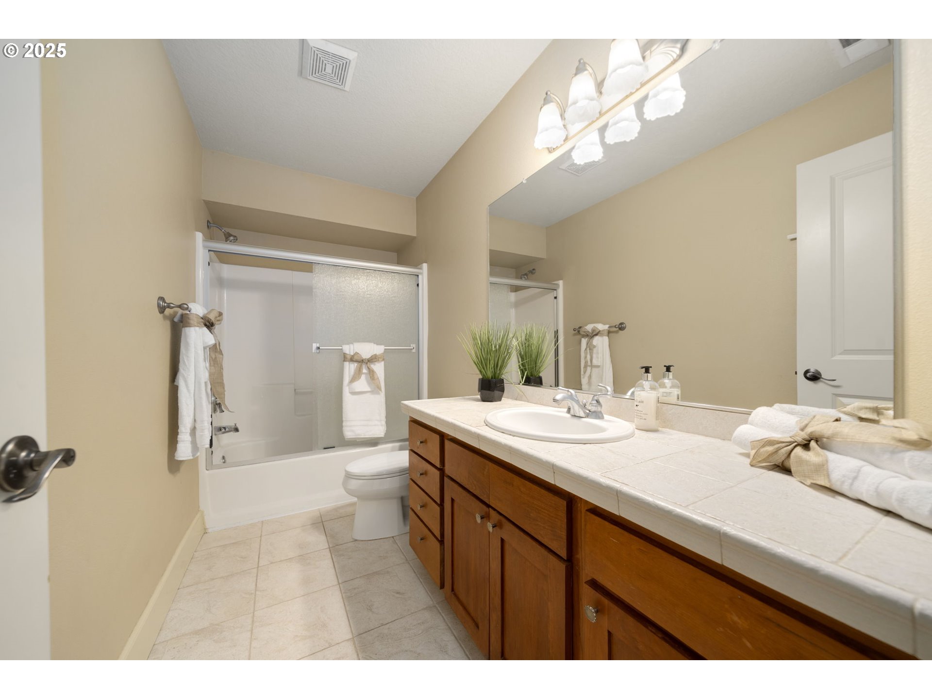 5219 Northwest Fernridge Drive Camas, WA 98607 - Photo 26 of 48 a bathroom with a sink a mirror and a shower