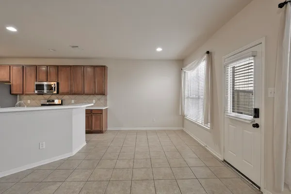 a kitchen with a stove a sink and a refrigerator