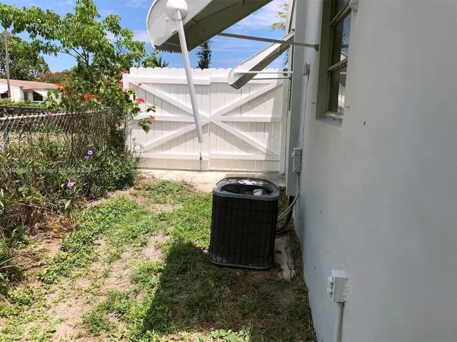 a backyard of a house with a garden and plants