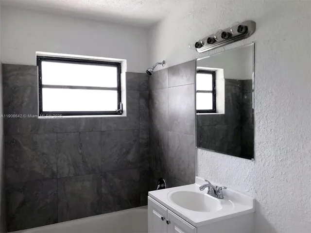 a bathroom with a sink toilet and mirror