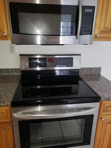 a stove top oven sitting inside of a kitchen