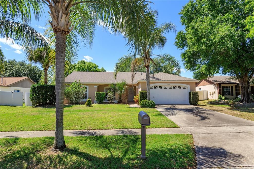 14433 Indian Ridge Trail Clermont, FL 34711 - Photo 1 of 1 a view of a house with a yard and palm trees