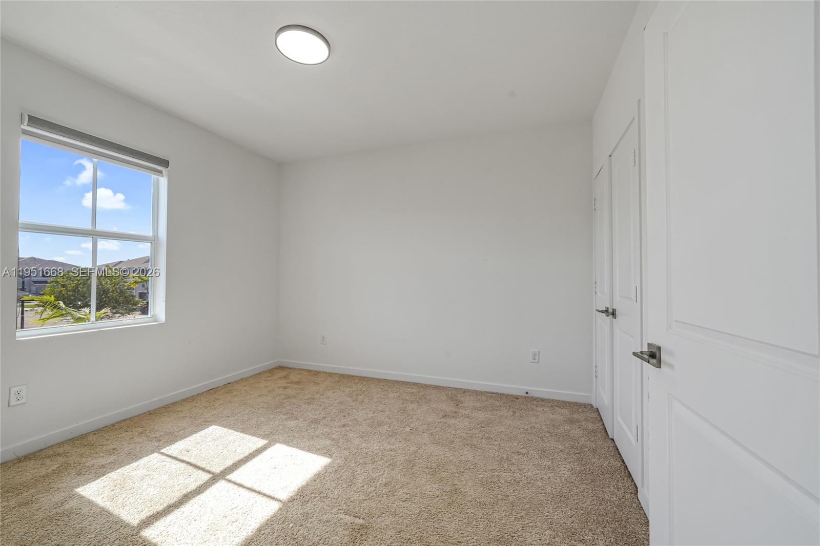 767 Southeast 18th Street Homestead, FL 33034 - Photo 12 of 29 an empty room with windows
