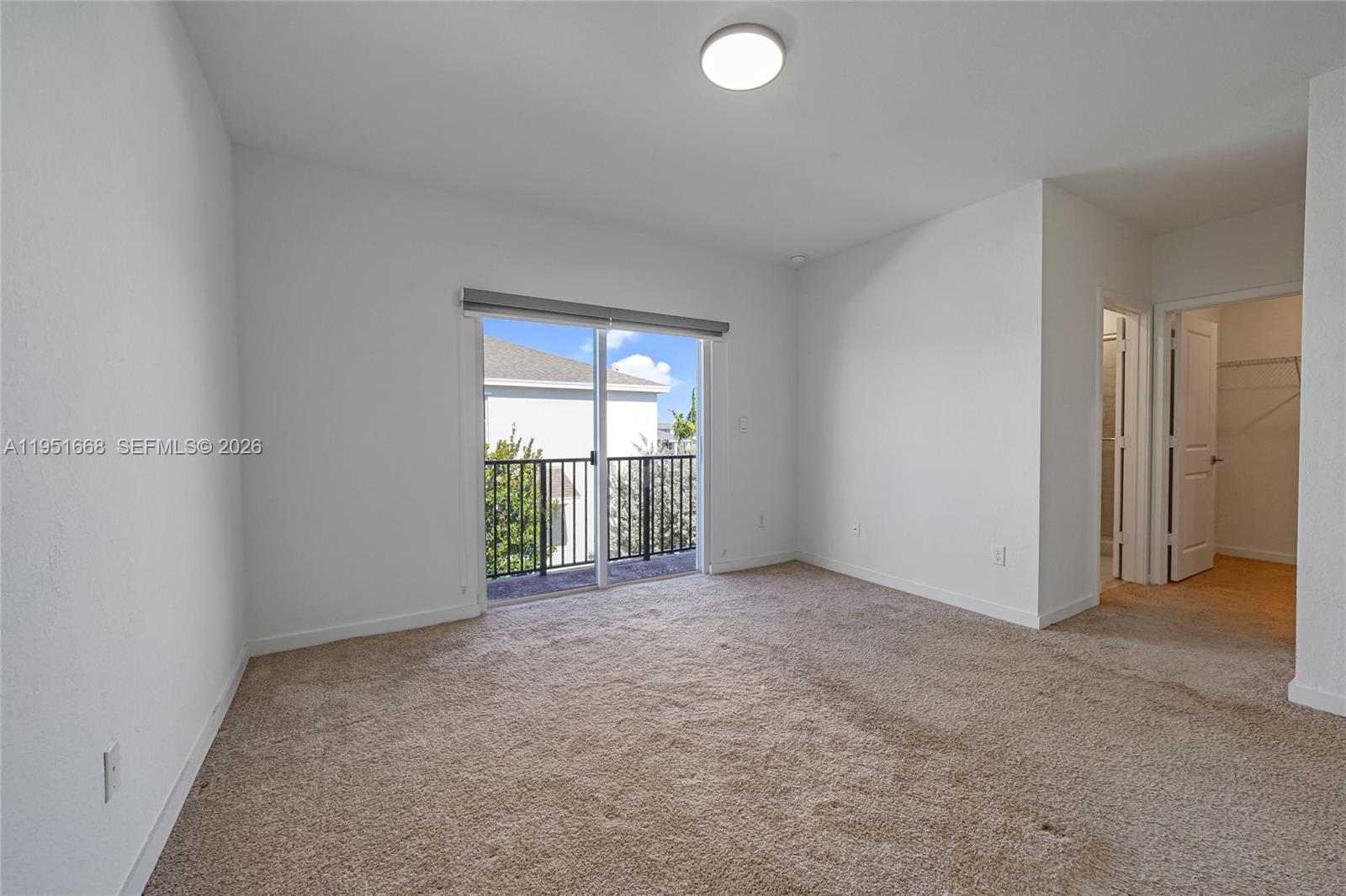 767 Southeast 18th Street Homestead, FL 33034 - Photo 16 of 29 an empty room with windows and fan