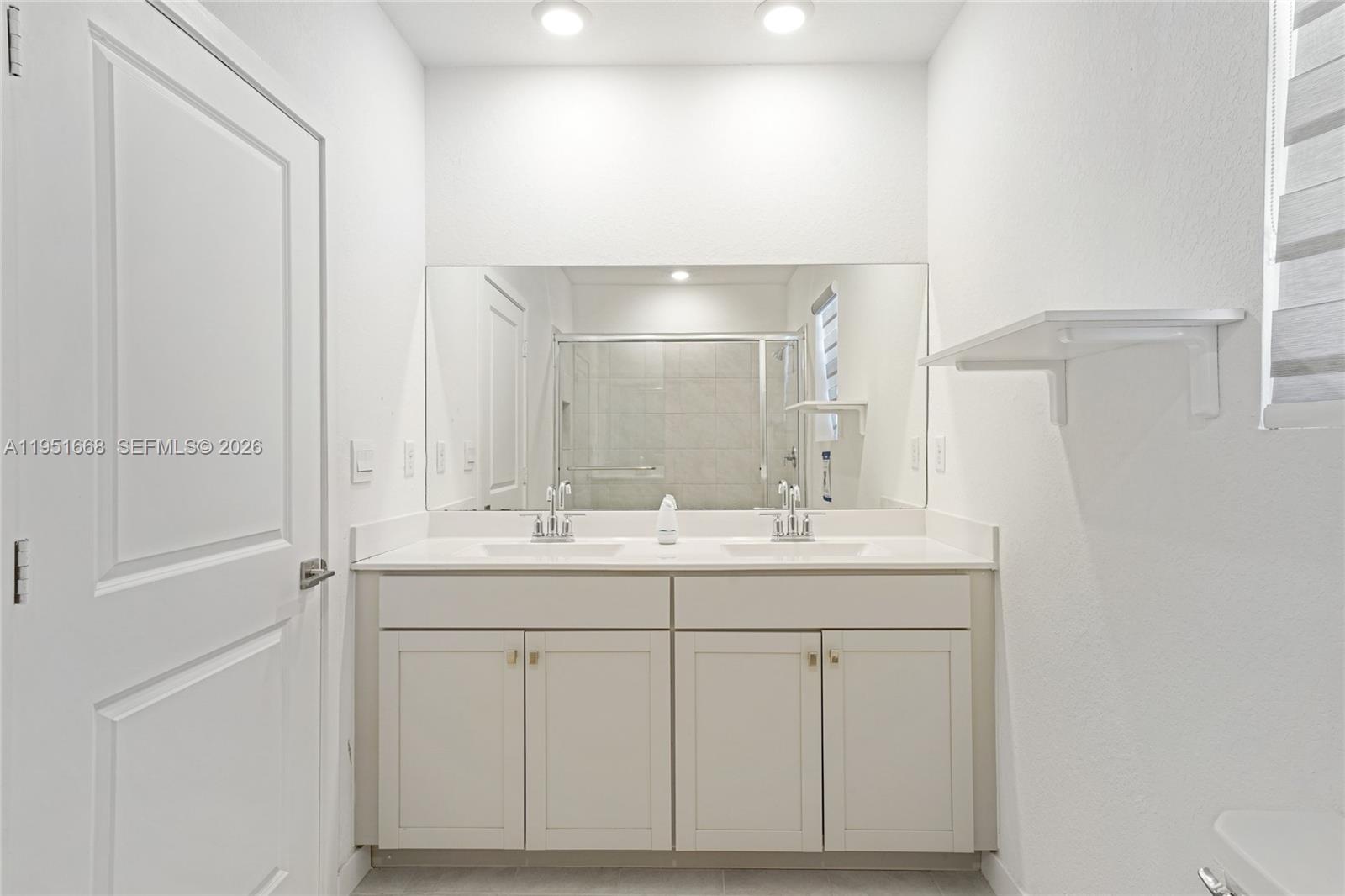 767 Southeast 18th Street Homestead, FL 33034 - Photo 19 of 29 a bathroom with a sink and a mirror