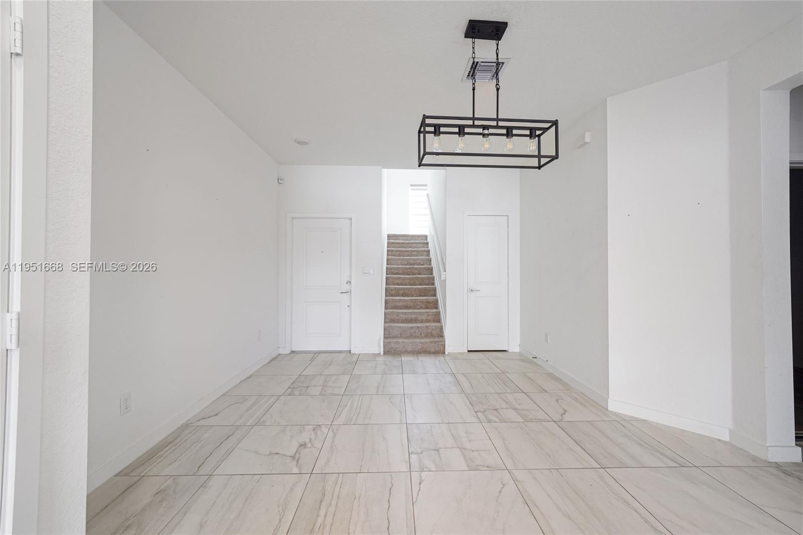 767 Southeast 18th Street Homestead, FL 33034 - Photo 2 of 29 a view of a hallway with a white walls