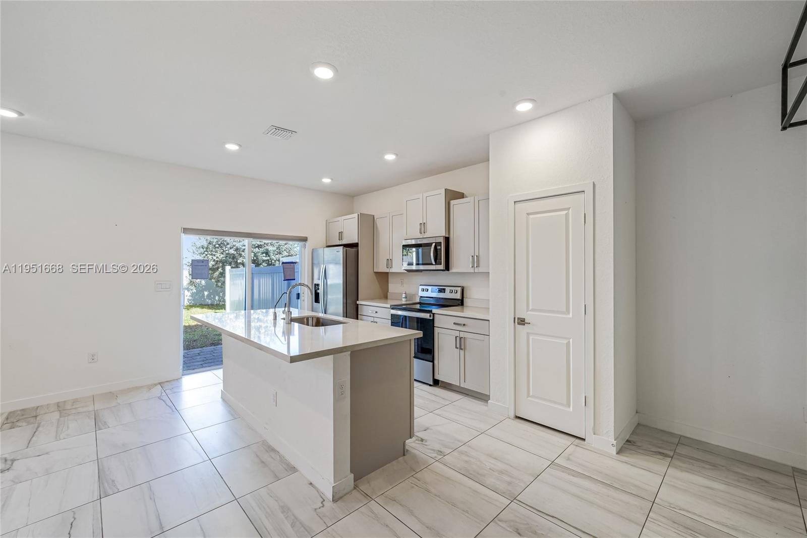 767 Southeast 18th Street Homestead, FL 33034 - Photo 3 of 29 a view of kitchen with stainless steel appliances granite countertop a stove and a refrigerator