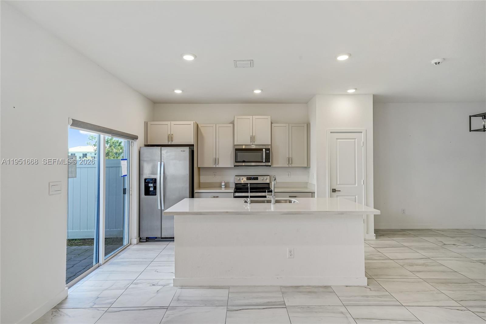767 Southeast 18th Street Homestead, FL 33034 - Photo 4 of 29 a large kitchen with stainless steel appliances lots of counter top space cabinets and a refrigerator