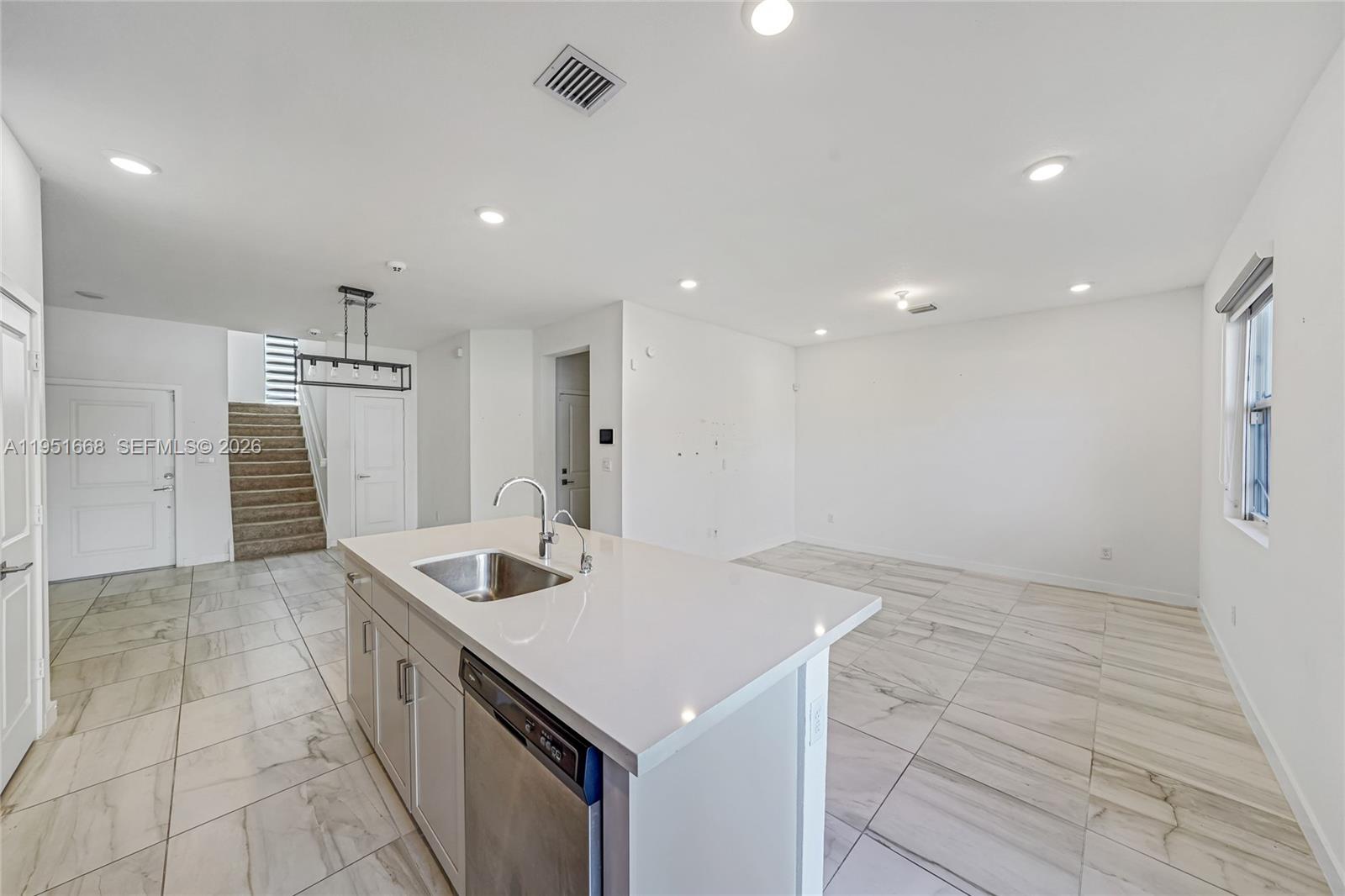 767 Southeast 18th Street Homestead, FL 33034 - Photo 6 of 29 a kitchen with a sink cabinets and refrigerator