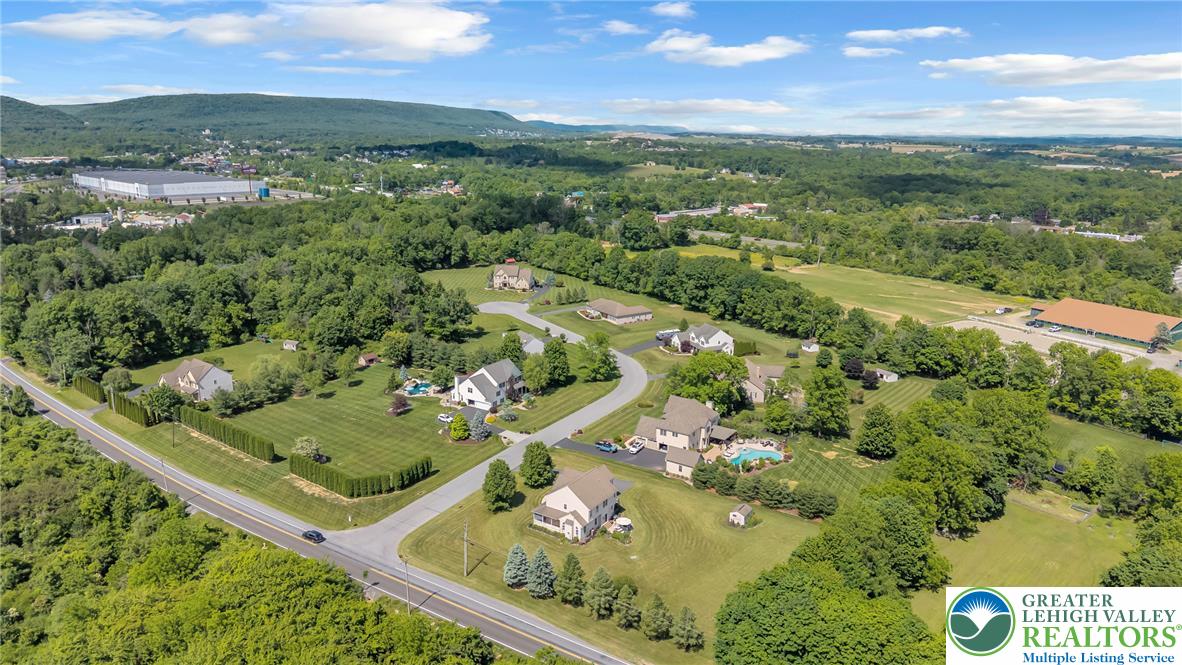 204 Bushkill Ridge Road Wind Gap, PA 18091 - Photo 46 of 48 An aerial perspective reveals a serene residential community nestled among verdant landscapes and distant hills.