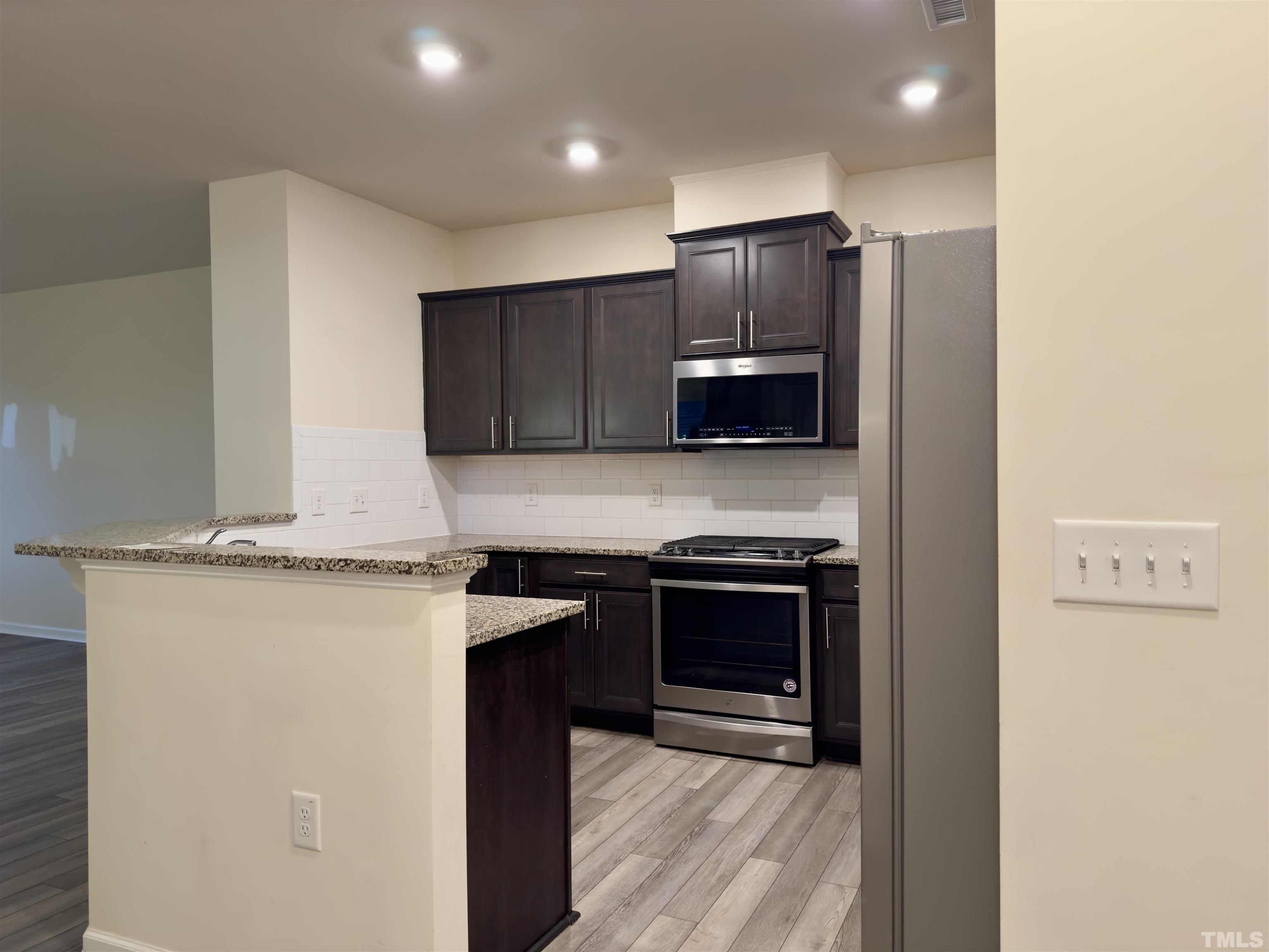 33 Rambler Lane Durham, NC 27703 - Photo 14 of 36 a kitchen with stainless steel appliances granite countertop a stove a refrigerator and a microwave