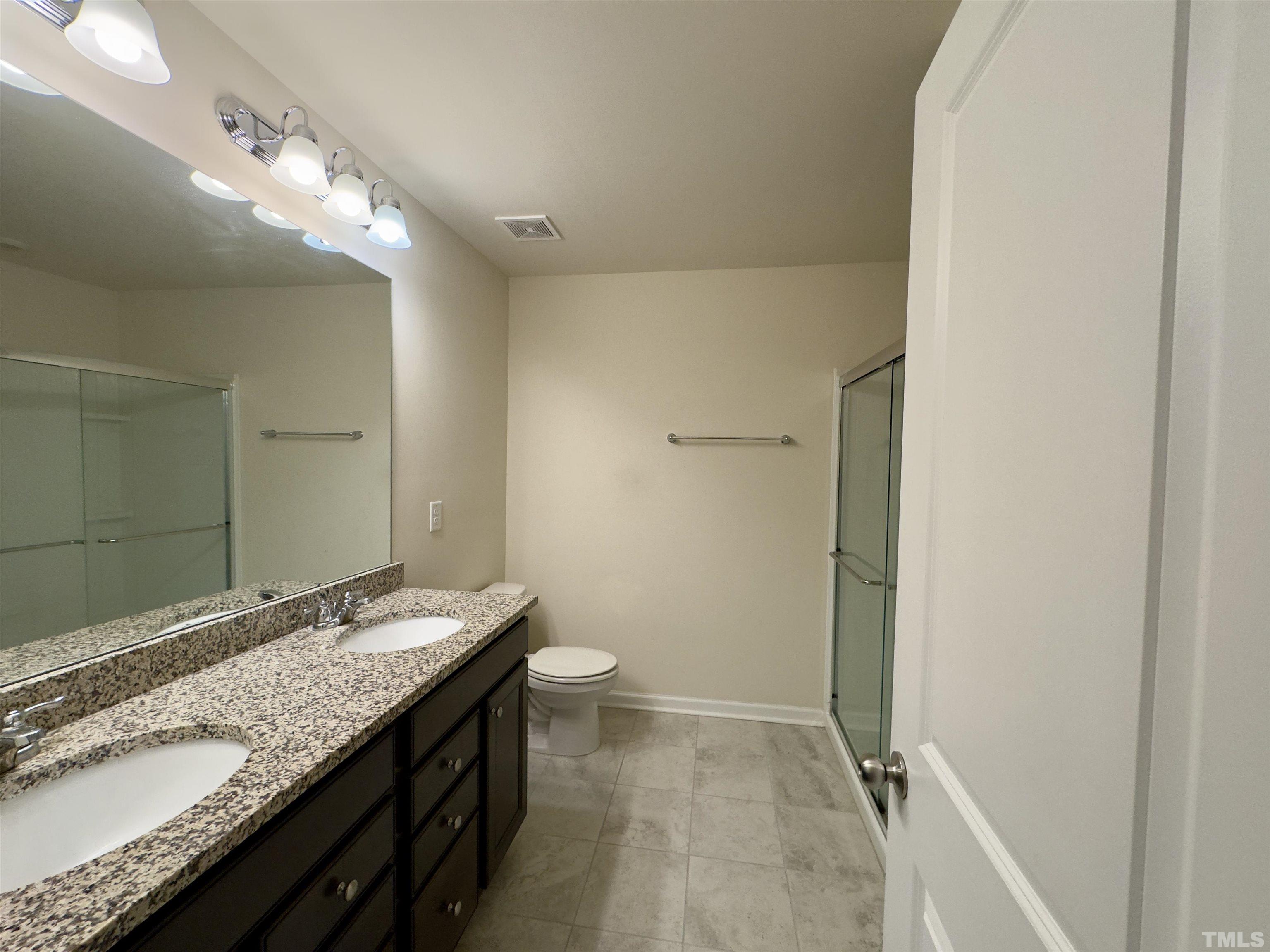 33 Rambler Lane Durham, NC 27703 - Photo 23 of 36 a bathroom with a granite countertop sink and a mirror