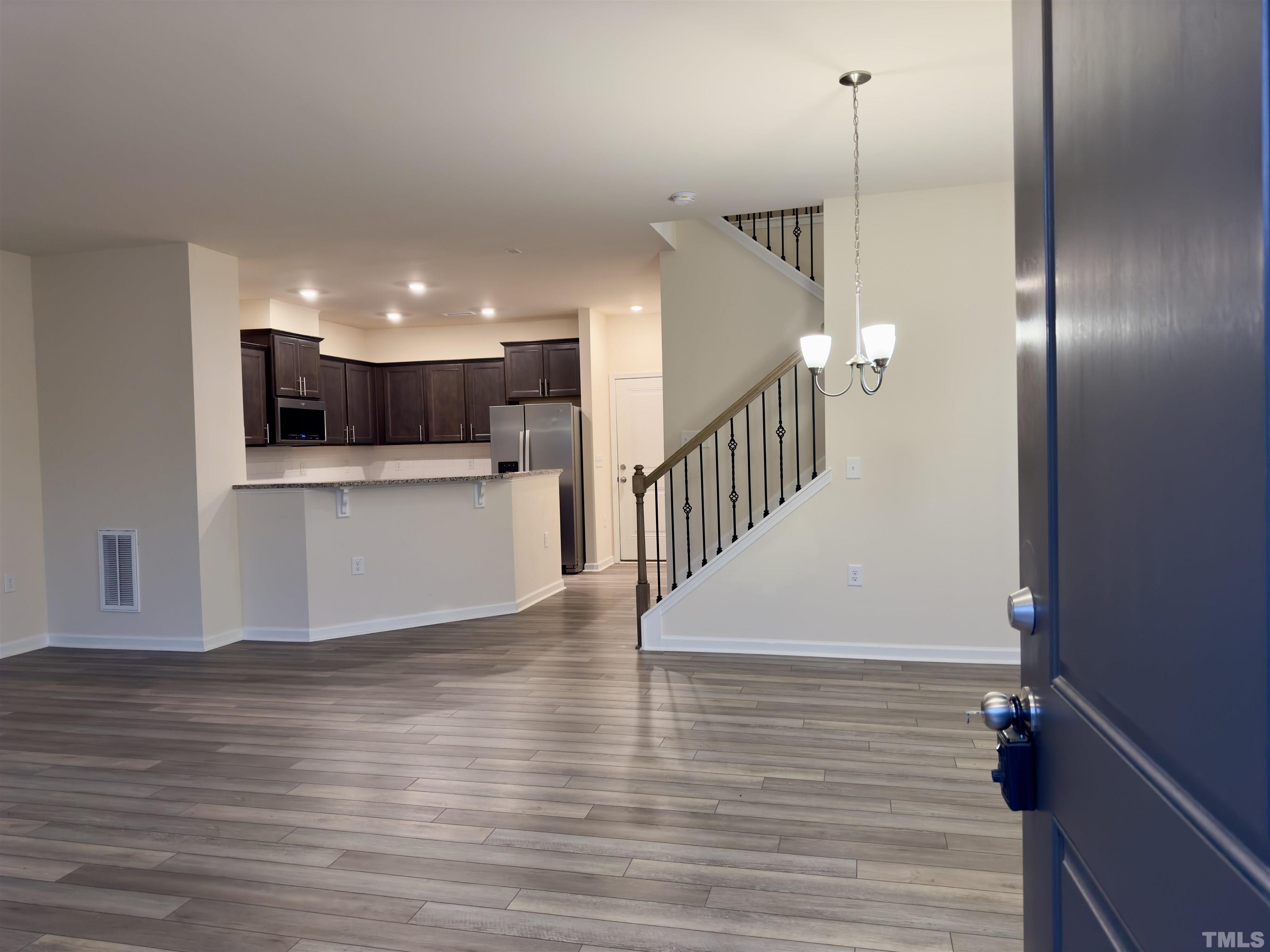 33 Rambler Lane Durham, NC 27703 - Photo 3 of 36 a view of a kitchen with a wooden floor and white walls
