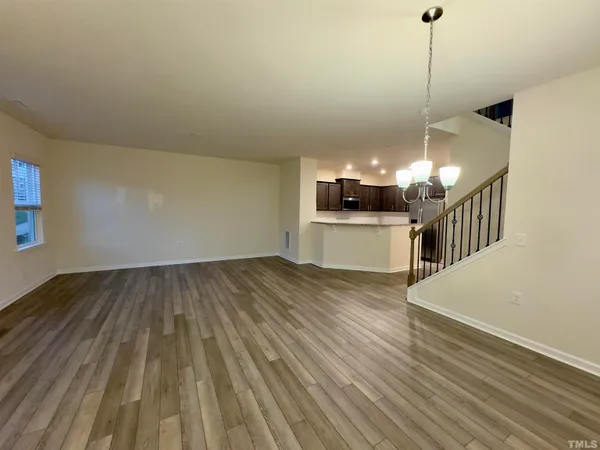 a view of a room with wooden floor