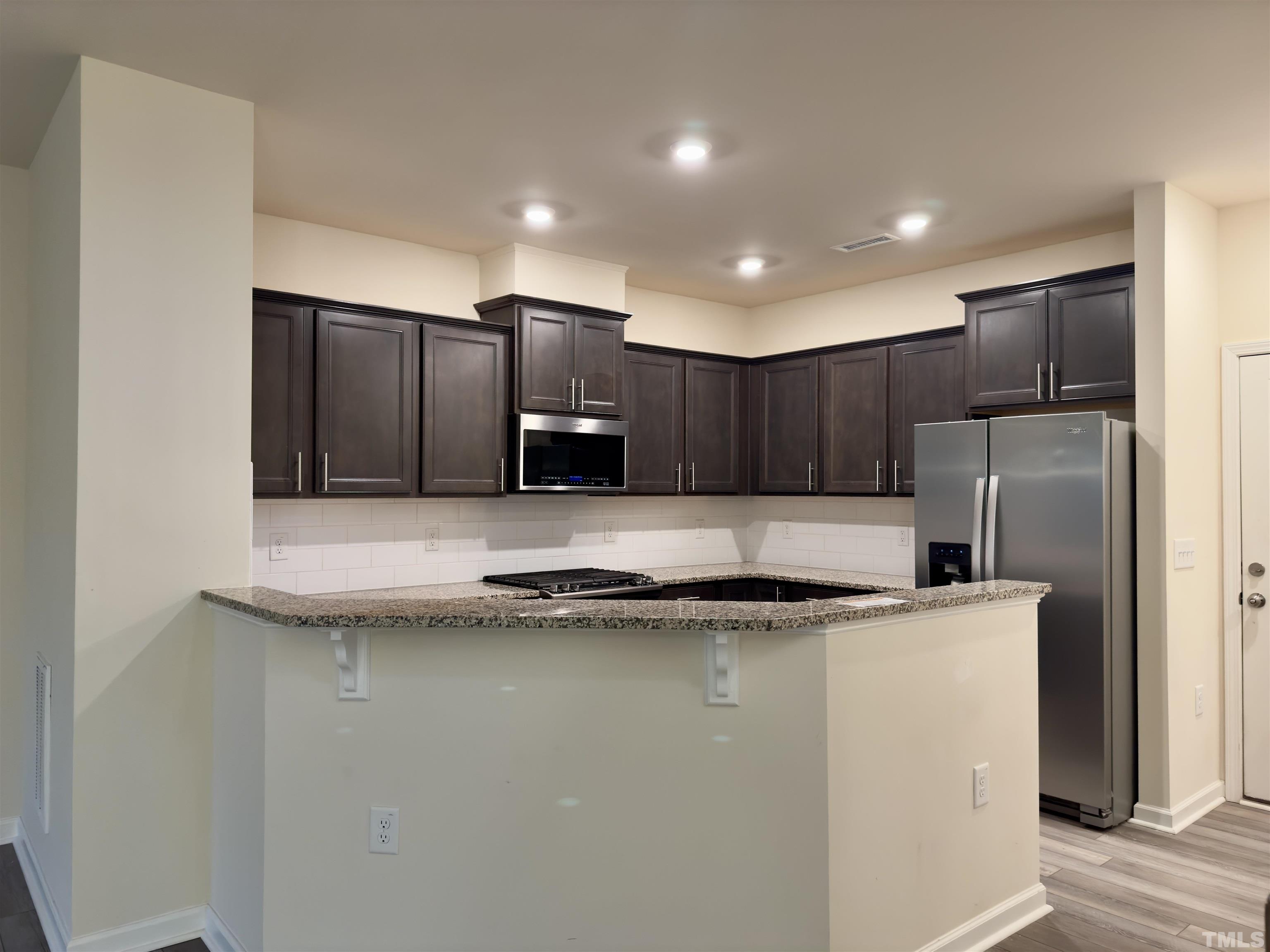 33 Rambler Lane Durham, NC 27703 - Photo 10 of 36 a kitchen with stainless steel appliances granite countertop a sink a refrigerator and a stove