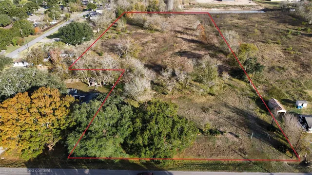 a view of a yard with wooden fence