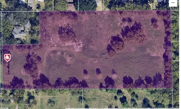 a view of a dry yard with green space