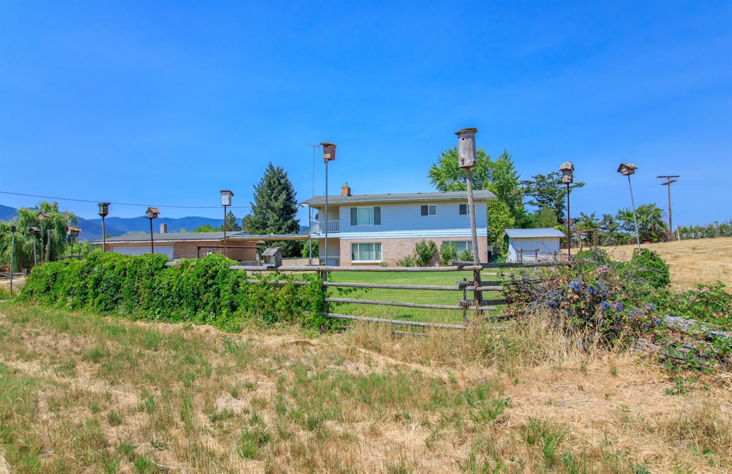 1039 West Valley View Road Ashland, OR 97520 - Photo 22 of 32 a view of a garden with a building in the background