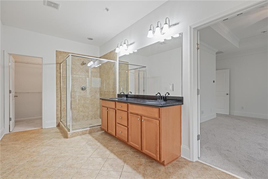 232 Hunt Street Northeast Marietta, GA 30060 - Photo 22 of 29 a spacious bathroom with a shower sink and a mirror