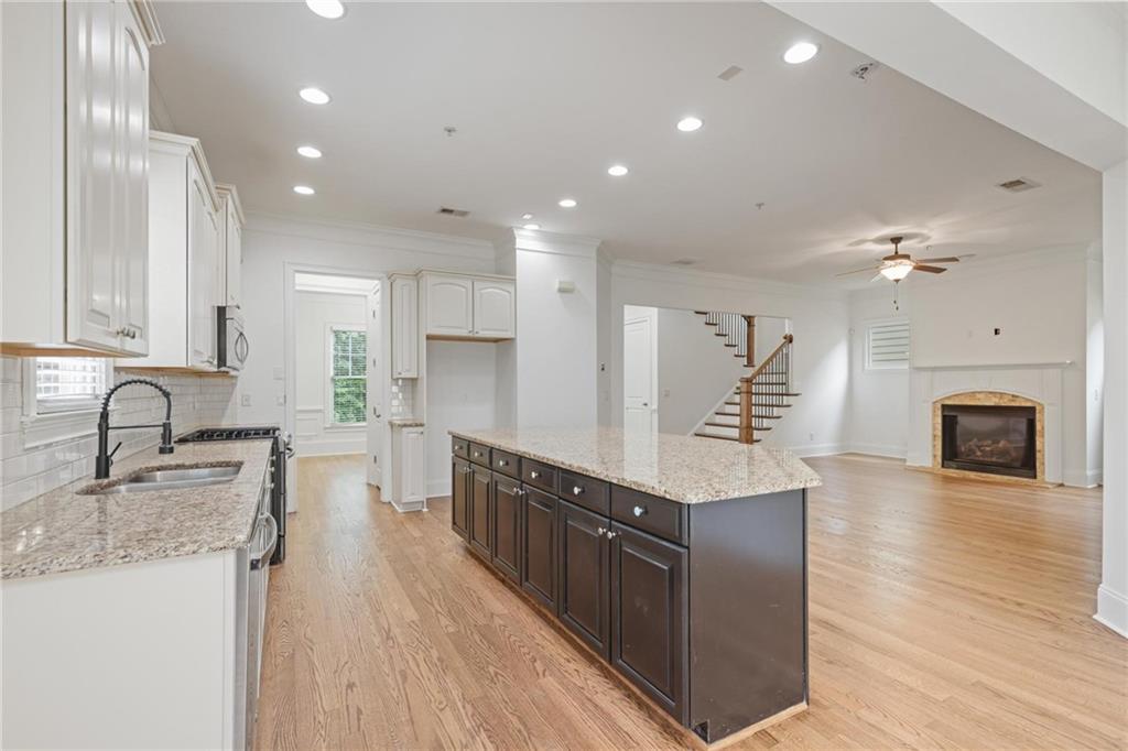 232 Hunt Street Northeast Marietta, GA 30060 - Photo 5 of 29 a large kitchen with stainless steel appliances granite countertop a lot of counter space and wooden floor