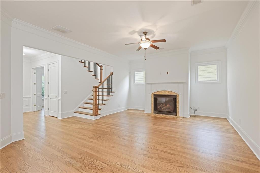 232 Hunt Street Northeast Marietta, GA 30060 - Photo 6 of 29 a view of an empty room with wooden floor and a fireplace