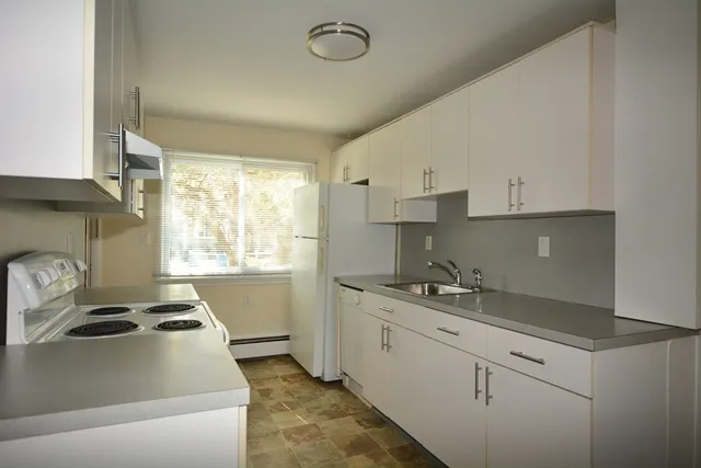 a kitchen with a sink stove and cabinets