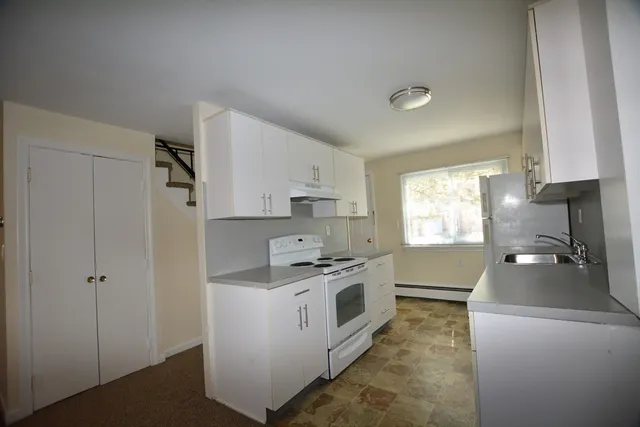 a kitchen with a stove a sink and a refrigerator