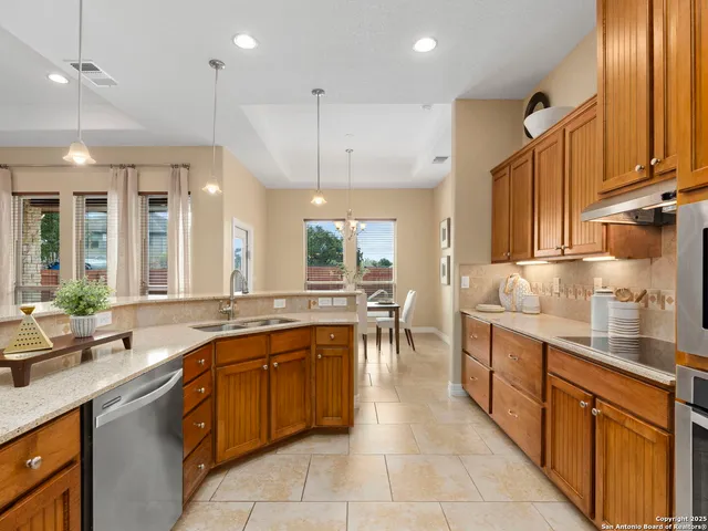 a kitchen with a sink refrigerator and microwave