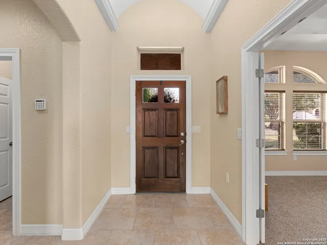 a bedroom with a large bed and a large window