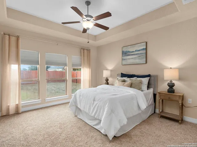 a spacious bedroom with a bed and a chandelier