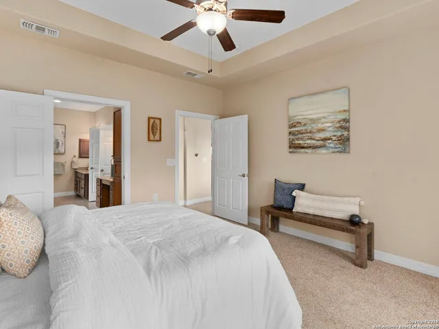 a spacious bathroom with a granite countertop double vanity sink a mirror and a shower