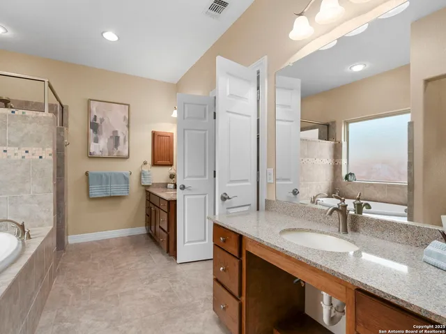a white bath tub sitting next to a shower