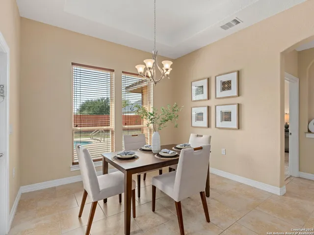 a view of a dining room with furniture and chandelier