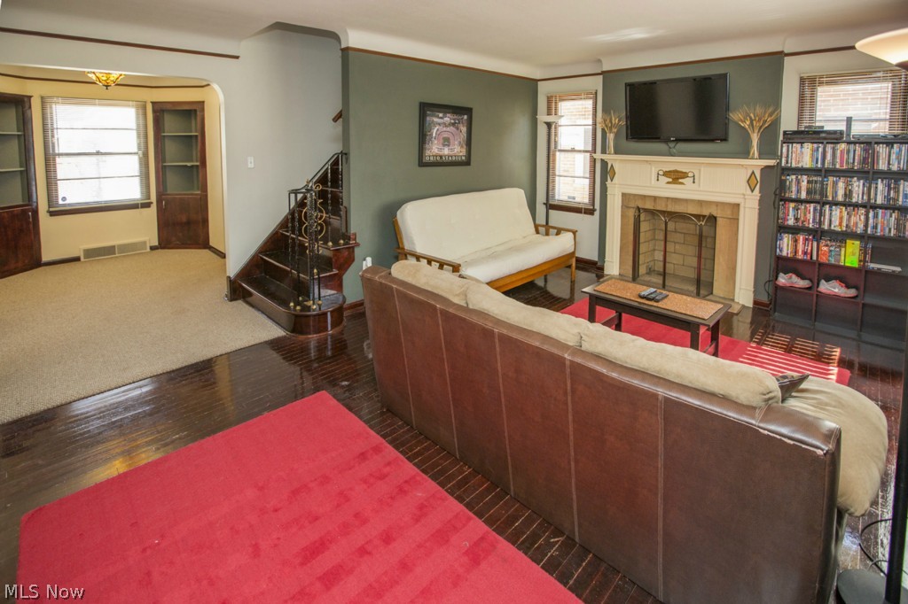 17207 Neff Road Cleveland, OH 44119 - Photo 5 of 25 Cozy living room with refinished wood floors, woodburning fireplace and lots of natural light.