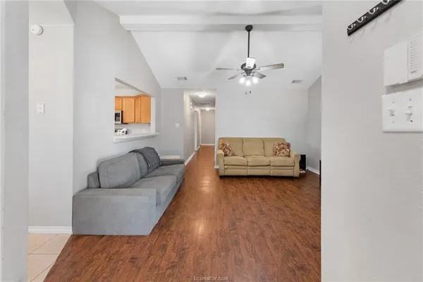 a living room with furniture and a ceiling fan