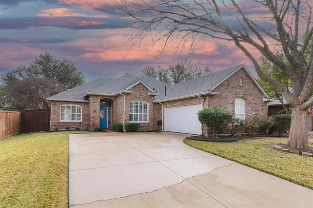 a front view of house with yard and trees