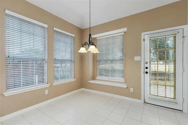 a kitchen with white cabinets appliances and sink