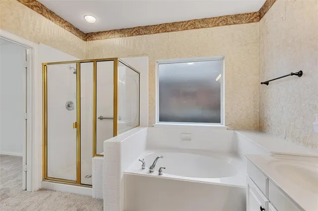 a bathroom with a double vanity sink mirror and bathtub