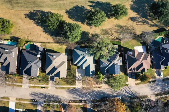 a view of a house with a backyard and a tree