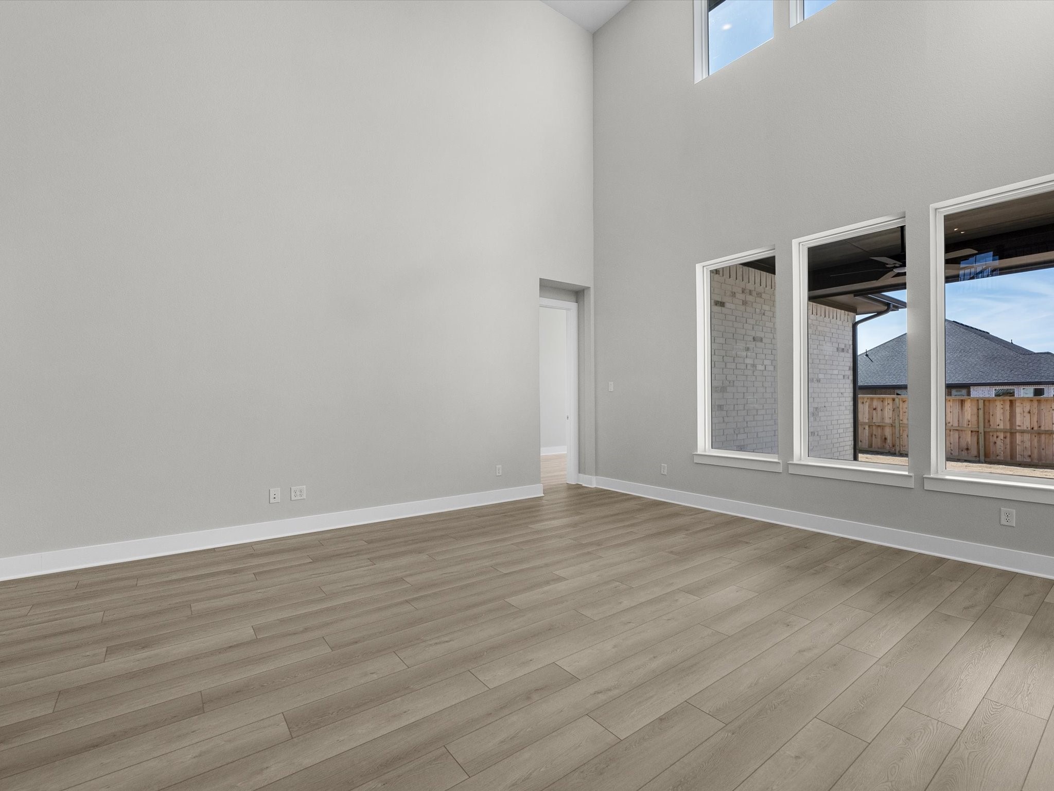 7922 Antler Rdg Drive Fulshear, TX 77441 - Photo 7 of 31 a view of an empty room with wooden floor and windows
